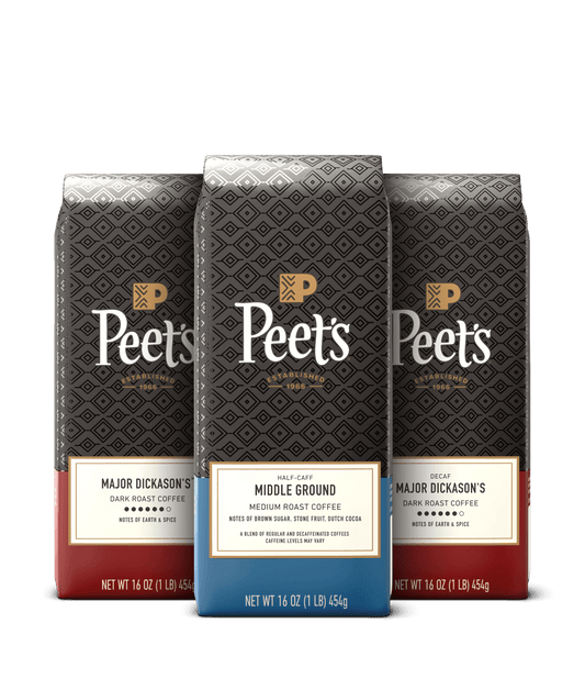 Three Peet's coffee bags with different roast levels on a black background
